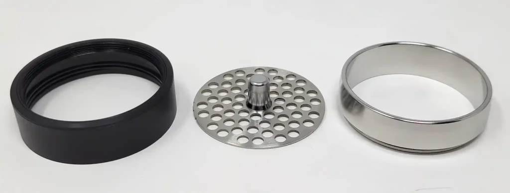 Flower Mill grinder's midsection unscrews to change the stainless steel grind plate