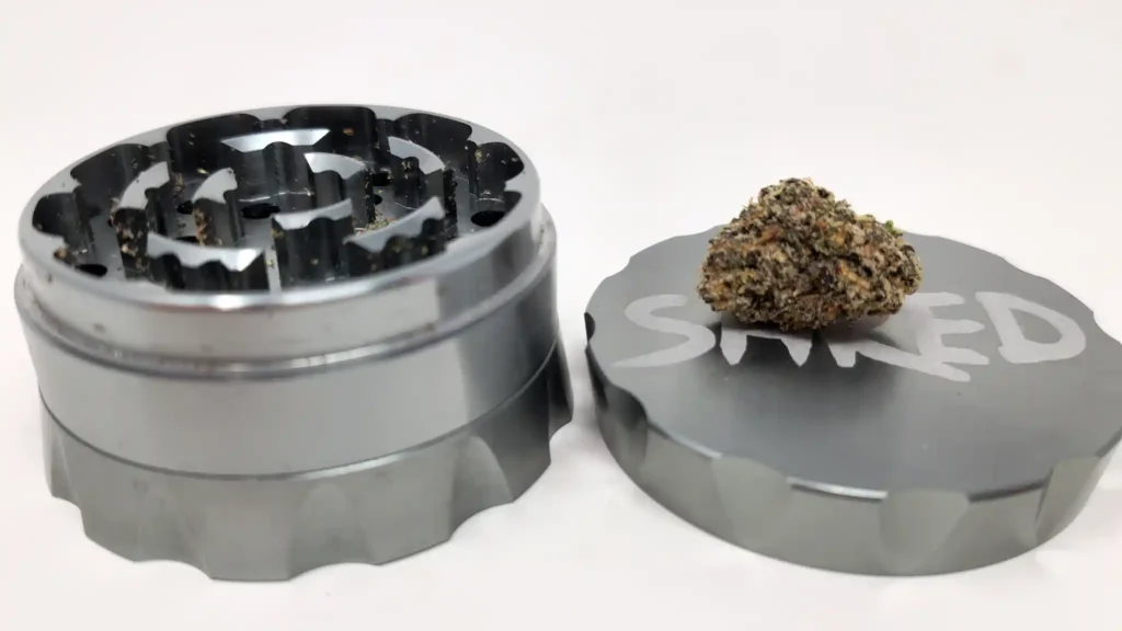 Healthy Rips SHRED 2.25" grinder with a dark purple nug of crunchberries on its top