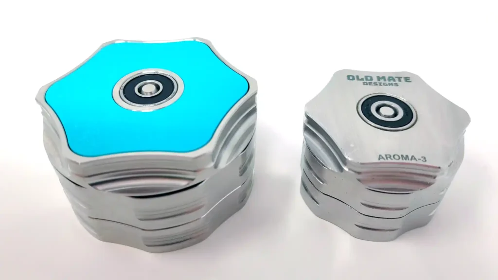 XL Aroma 3 Stainless Steel weed grinder next to the original ball bearing spinning grinder