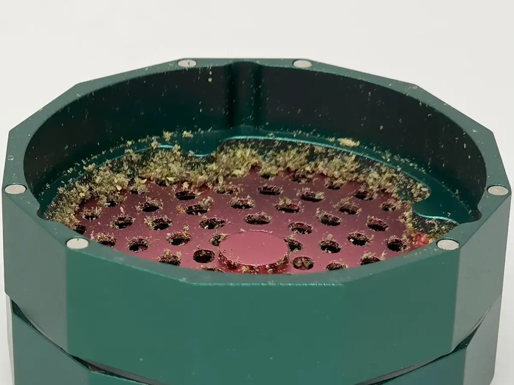 Underside of the used CAPU grinder shows significant accumulated herb