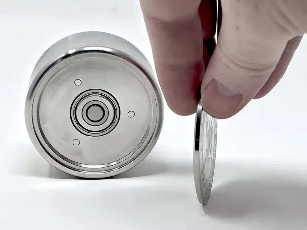 The spinning grinder bearing cover removed to exposed the magnets and skateboard bearing