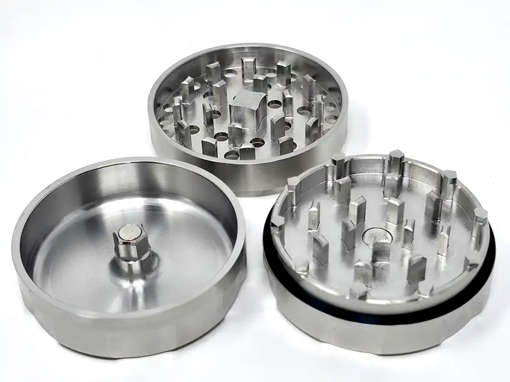 Draken 2 three piece stainless steel weed grinder on white surface